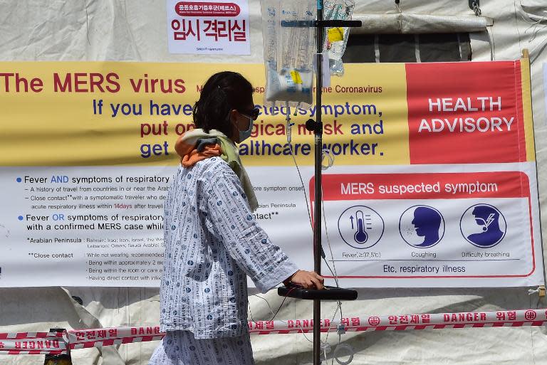 A man walks in front of a quarantine tent for suspected MERS cases at the Seoul National University Hospital in Seoul on June 2, 2015