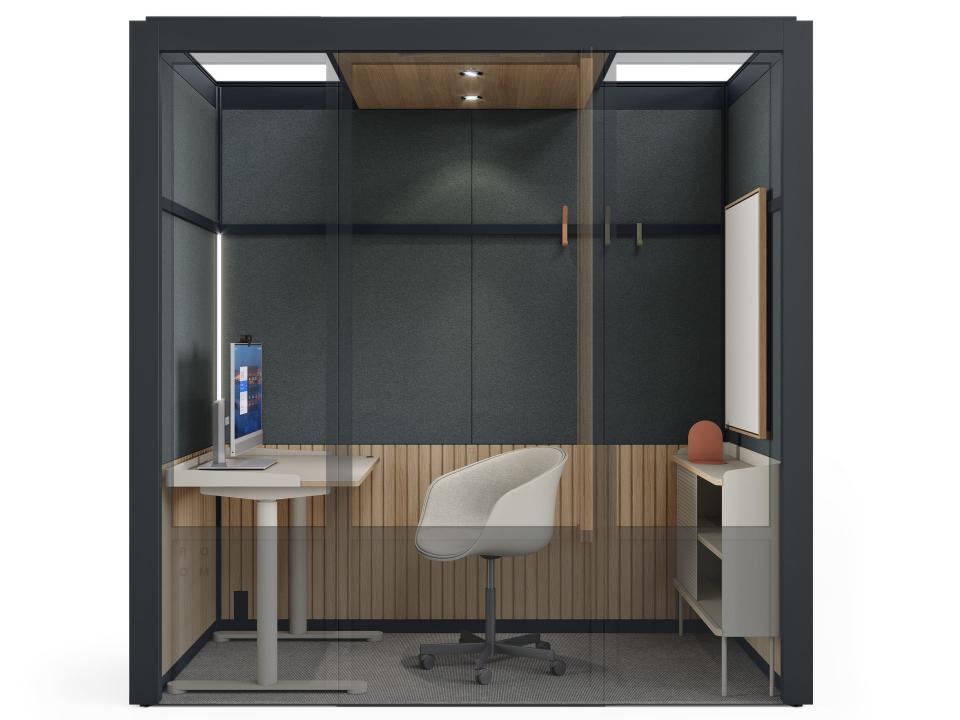 a rendering of a Room for Zoom booth with a black frame and a chair, desk, whiteboard, desktop