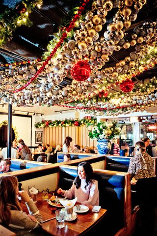 <p>Gabriela Herman</p> Hudson House, a popular spot for burgers and happy hour, adorns its ceiling with lights and shiny ornaments.