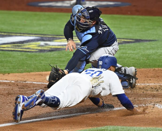 ARLINGTON, TEXAS OCTOBER 20, 2020-Dodgers Mookie Betts beats the tag of Rays catcher Mike Zunino.