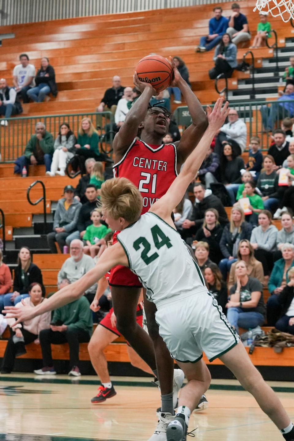 Center Grove Trojans Michael Ephraim (21) scores a layup against Zionsville Eagles Luke Reasoner (24) on Tuesday, Feb. 6, 2024, during the game at Zionsville High School in Zionsville, Indiana. The Center Grove Trojans defeated the Zionsville Eagles 60-49.