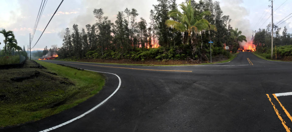 <p>In this handout photo provided by the U.S. Geological Survey, a panoramic view of a fissure errupting lava from the intersection of Leilani and Makamae Streets after the eruption of Hawaii’s Kilauea volcano on May 5, 2018 in the Leilani Estates subdivision near Pahoa, Hawaii. The governor of Hawaii has declared a local state of emergency near the Mount Kilauea volcano after it erupted following a 5.0-magnitude earthquake, forcing the evacuation of nearly 1,700 residents. (Photo from U.S. Geological Survey via Getty Images) </p>