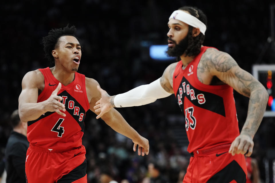 Toronto Raptors forward Scottie Barnes (4) and guard Gary Trent Jr. (33) celebrate a basket against the Miami Heat during the second half of an NBA basketball game Wednesday, Jan. 17, 2024, in Toronto. (Frank Gunn/The Canadian Press via AP)