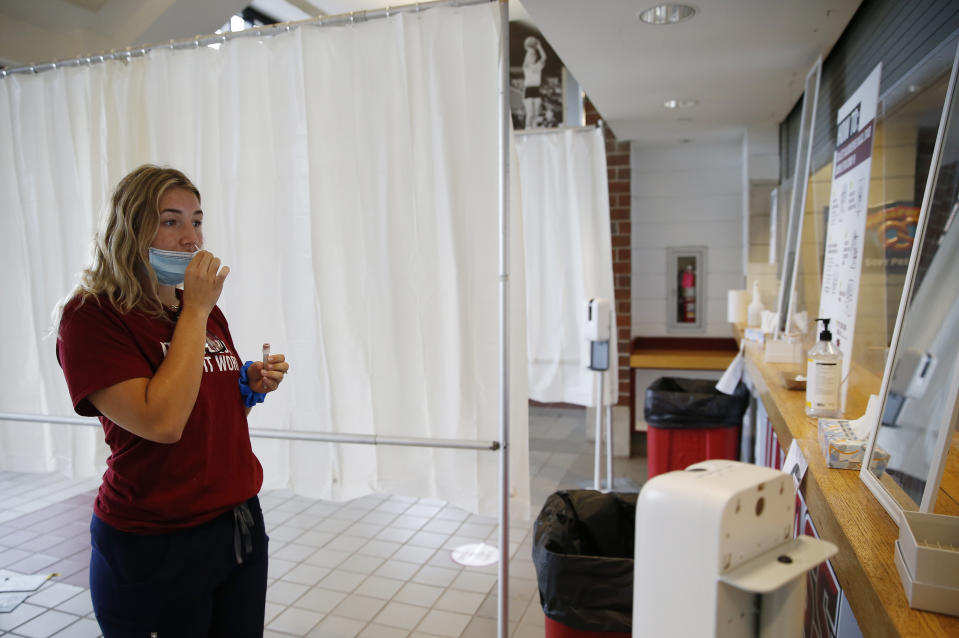 AMHERST, MA - SEPTEMBER 9: Caroline Ricciardi, a Senior Nursing Student at UMass Amherst demonstrates how a student would self administer a COVID-19 test by swabbing the inside of their nostrils inside the school's coronavirus testing site in Amherst, MA on Sept. 9, 2020. (Photo by Jessica Rinaldi/The Boston Globe via Getty Images)