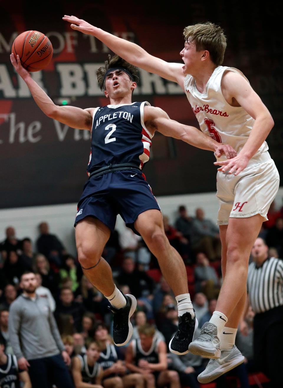 Appleton East's Joey La Chapell, left, is fouled as he scores a basket against Hortonville's Drake Johnson during their game in December.