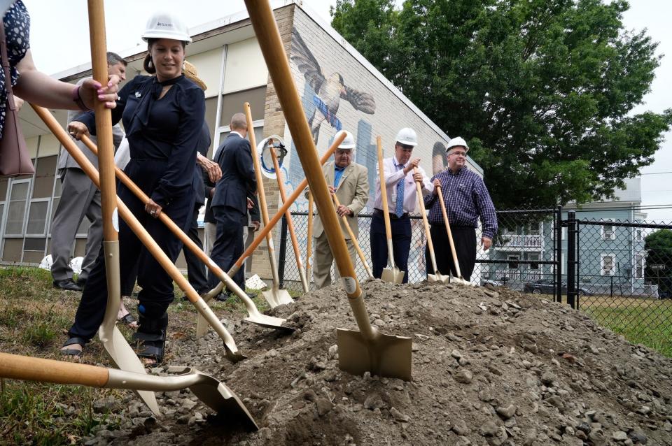 Rhode Island education Commissioner Angélica Infante-Green, among a number of city and state officials present, turns over a little more dirt with a shovel at the groundbreaking for renovations at William D’Abate Elementary School in Providence on Wednesday.