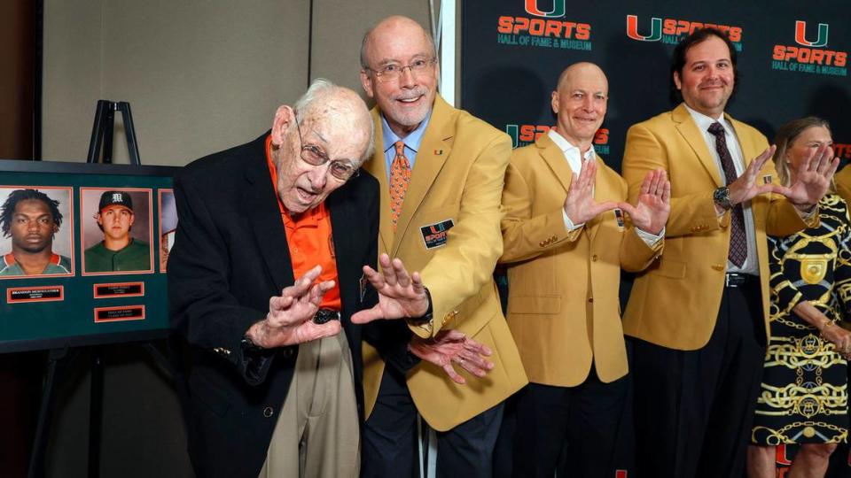 Inductees G. Holmes Braddock and athletic administrator Rick Remmert flash the U, along with Johan Donar and Chris Perez, left to right, during the University of Miami’s Sports Hall of Fame & Museum 54th Induction Banquet on campus at the Watsco Center in Coral Gables.