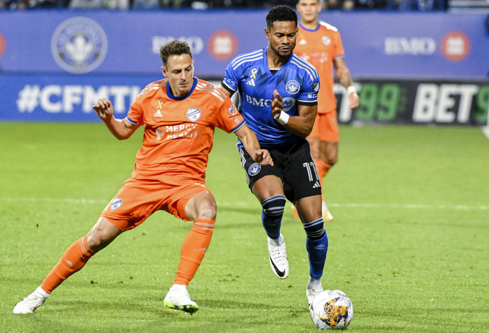 CF Montreal's Ariel Lassiter, right, and FC Cincinnati's Santiago Arias go for the ball during the first half of an MLS soccer match Wednesday, Sept. 20, 2023, in Montreal. (Graham Hughes/The Canadian Press via AP)