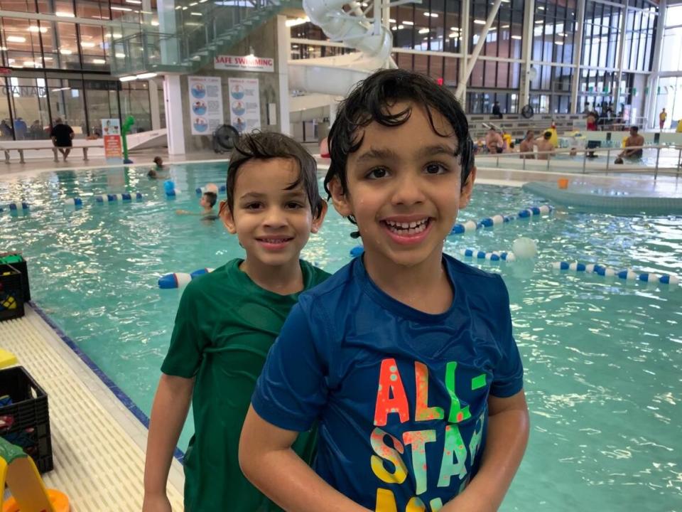 Nishan and Nirav Saggu work with an ASL interpreter during their swim lessons at the Meadows rec centre.  (Caitlin Hanson/CBC - image credit)