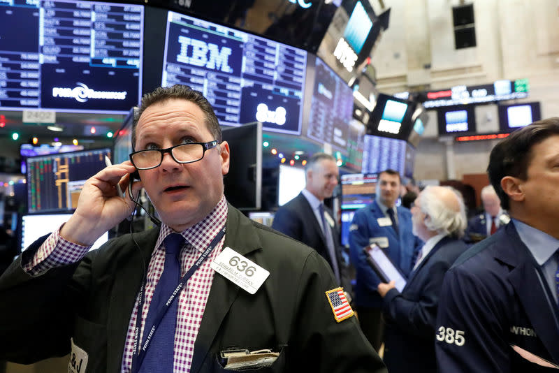 Traders work on the floor of the New York Stock Exchange (NYSE) in New York, U.S., December 13, 2017. REUTERS/Brendan McDermid