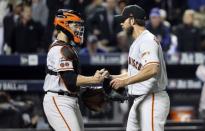 Oct 5, 2016; New York City, NY, USA; San Francisco Giants starting pitcher Madison Bumgarner (right) and catcher Buster Posey (left) celebrate the win against the New York Mets in the National League wild card playoff baseball game at Citi Field. Mandatory Credit: Anthony Gruppuso-USA TODAY Sports