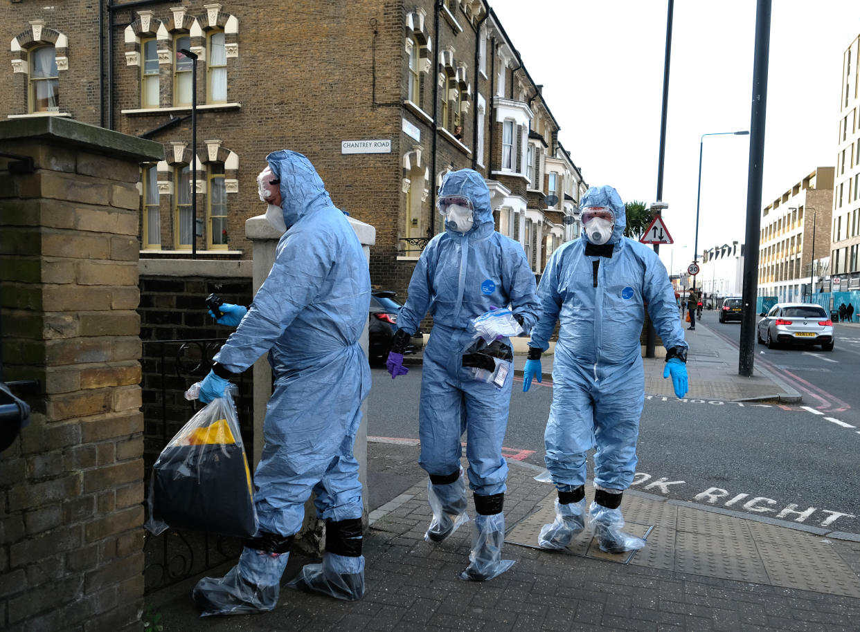 Three police officers wearing Personal Protective Equipment (PPE) as a precautionary measure against Covid-19, visit a home in Brixton, south London, as the UK continues in lockdown to help curb the spread of the coronavirus. Picture date: Monday April 6, 2020. 