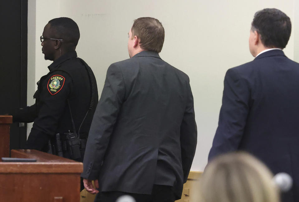 Aaron Dean, center, is escorted out of the courtroom after sentencing on Tuesday, Dec. 20, 2022, at Tarrant County's 396th District Court at the Tim Curry Criminal Justice Center in Fort Worth, Texas. Former Fort Worth police officer Dean was sentenced to nearly 12 years after being convicted of manslaughter in the 2019 killing of Atatiana Jefferson. (Amanda McCoy/Star-Telegram via AP, Pool)