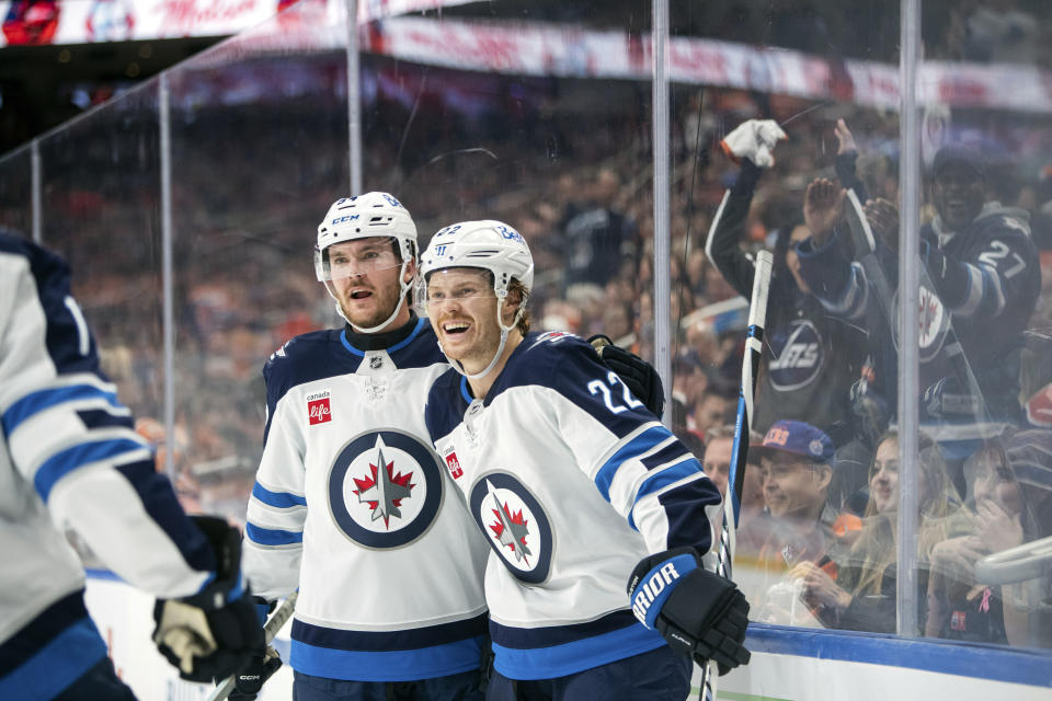 Winnipeg Jets' Mason Appleton (22) and Dylan Samberg (54) celebrate a goal against the Edmonton Oilers during the first period of an NHL hockey game, Wednesday, Oct. 9, 2024 in Edmonton, Alberta. (Amber Bracken/Canadian Press via AP)