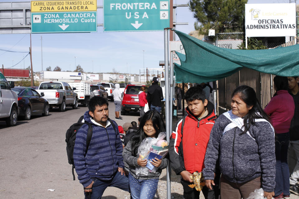 The Gonzalez family of five from Guatemala, who are applying for asylum in the U.S., stand for a family portrait before going to a soup kitchen to eat in Nogales, Mexico, on the U.S. border, Friday, Jan. 3, 2020. The family was sent by U.S. authorities to Nogales, Mexico on Thursday as part of the so-called “Remain in Mexico” program, and have a court appointment in El Paso on March 23. Lorenzo Gonzalez said the five of them were separated while being processed in the U.S. immigration system, after they turned themselves in to authorities in the sister city Nogales, Arizona. (AP Photo/Luis Enrique Castillo)