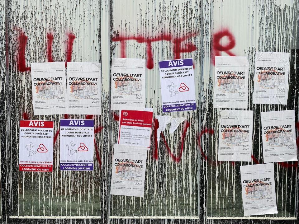 The building on Ontario street is covered in paint, posters and graffiti. 