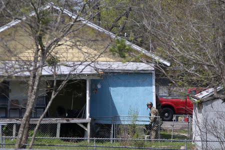 Law enforcement personnel investigate a home where the bomber was suspected to have lived in Pflugerville, Texas, U.S., March 21, 2018. REUTERS/Loren Elliott