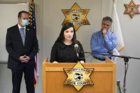 Cairenn Fullam-Binder, center, with the nonprofit organization called the DNA Doe Project, talks about the group's involvement in helping authorities identify "Gacy Victim 5" as North Carolina native Francis Wayne Alexander, during a news conference Monday, Oct. 25, 2021, in Maywood, Ill. Joining Fullam-Binder are Cook County Sheriff's Detective Lt. Jason Moran, left, and and Sheriff Tom Dart. (AP Photo/Charles Rex Arbogast)