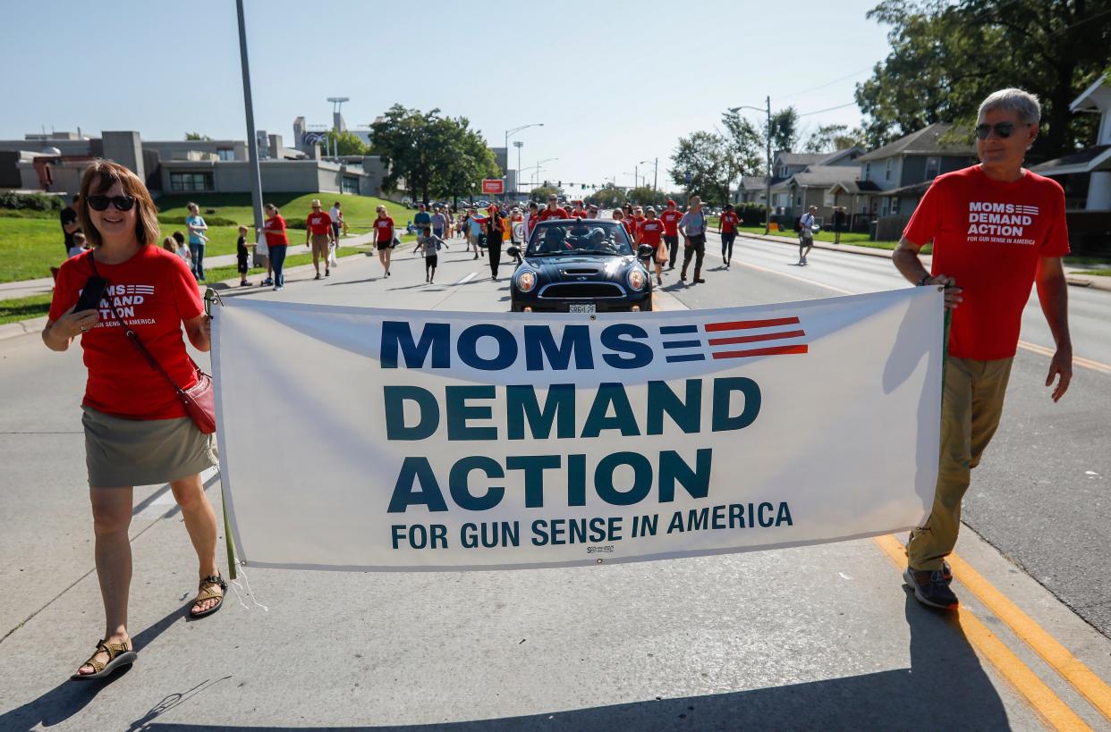 Members from the Moms Demand Action organization march during the Labor Day Parade on Monday, Sep. 2, 2019, in Springfield, Mo.