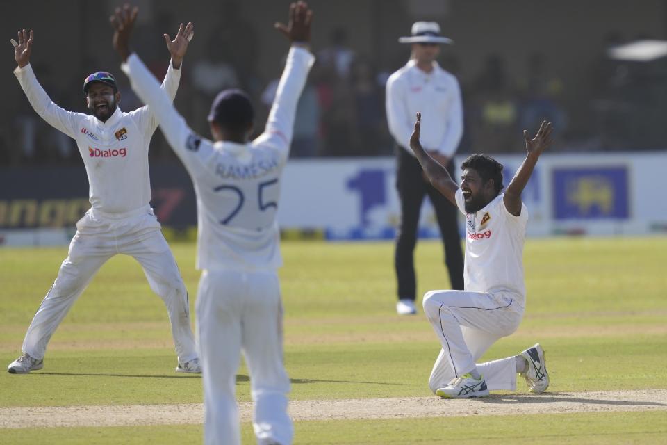 FILE - Sri Lanka's bowler Prabath Jayasuriya, right, successfully appeals to dismiss Australia's Cameron Green during the first day of the second cricket test match between Australia and Sri Lanka in Galle, Sri Lanka, Friday, July 8, 2022. Sri Lanka was in contention for the World Test Championship final until March. That prospect has whetted its appetite to get there in the new cycle. The campaign starts on Sunday, when Sri Lanka plays Pakistan in Galle in the first of two tests. (AP Photo/Eranga Jayawardena, File)