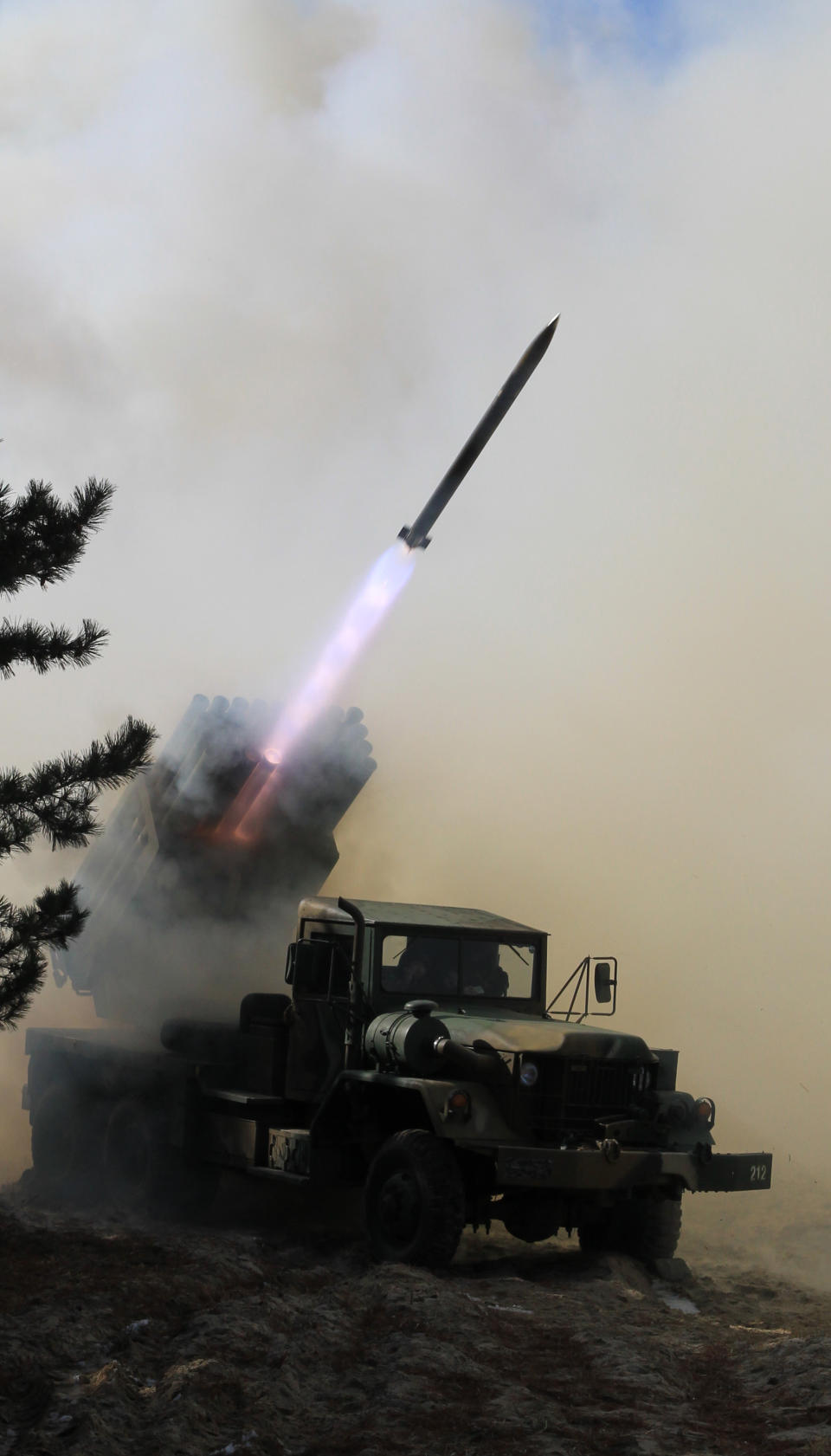 South Korean Army's 130mm multiple rocket launcher fires a live round during an exercise against possible attacks from North Korea in Goseong, South Korea, Monday, March 3, 2014. North Korea fired two additional suspected short-range missiles into the sea Monday amid ongoing military exercises between Seoul and Washington, which the North calls a preparation for an attack, South Korean officials said. (AP Photo/Yonhap, Lee Jong-gun) KOREA OUT