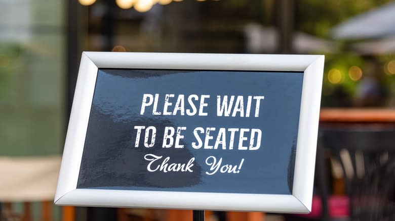 Wait to be seated sign