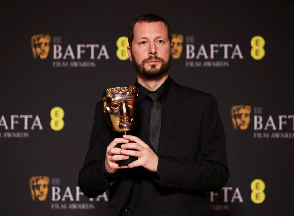 Mstyslav Chernov with the BAFTA award <span class="copyright">REUTERS/Hollie Adams</span>