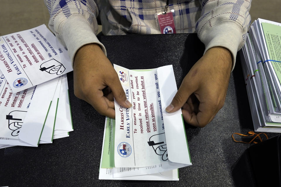 FILE - Harris County election worker Jose Vasquez prepares mail-in ballots to be sent to voters in Houston on Sept. 29, 2020. Elections in Harris County, Texas, home to Houston, the state's biggest city, are coming under the microscope this week as the Democratic stronghold faces unprecedented intervention from the state’s GOP-led Legislature. (AP Photo/David J. Phillip, File)