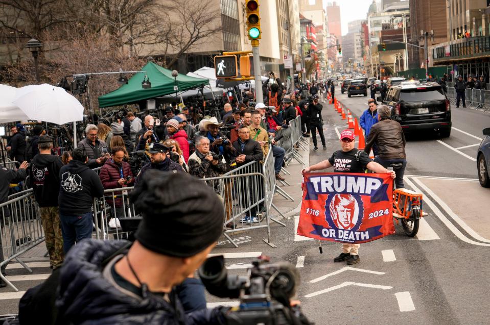 Supporters of Former President Donald Trump gather in front of assembled media and onlookers outside Manhattan Criminal Court, Tuesday, April 4, 2023, in New York. Trump is expected to travel to New York to face charges related to hush money payments. Trump is facing multiple charges of falsifying business records, including at least one felony offense, in the indictment handed up by a Manhattan grand jury. (AP Photo/John Minchillo)