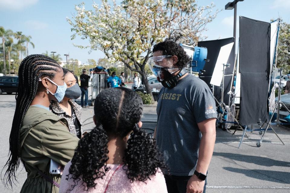 Behind the scenes, director Jon Huertas (who also plays Miguel) discusses a scene with Eris Baker (Tess), Lyric Ross (Deja) and Faithe Herman (Annie).