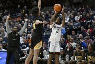 UConn guard Tristen Newton (2) shoots over Arkansas-Pine Bluff guard Joe French in the first half of an NCAA college basketball game, Saturday, Dec. 9, 2023, in Storrs, Conn. (AP Photo/Jessica Hill)