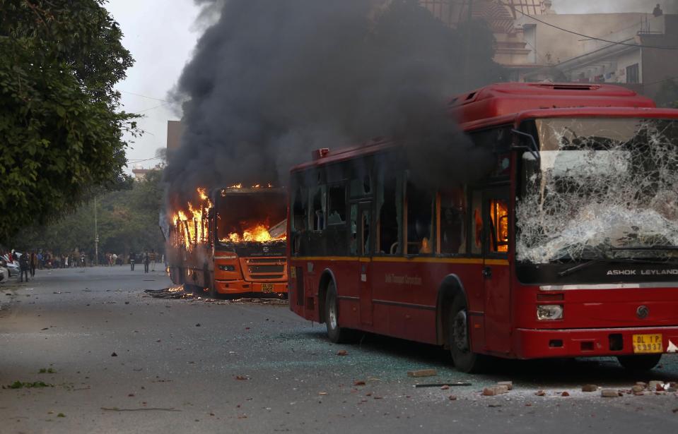 Passenger buses go up in flames during a protest against Citizenship Amendment Act in New Delhi, India, Sunday, Dec. 15, 2019. Protests have been continuing over a new law that grants Indian citizenship based on religion and excludes Muslims. (AP Photo)