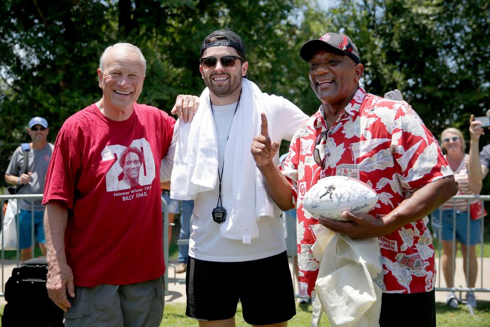 Baker Mayfield, center, poses for a photo with former OU coach Barry Switzer, left, and fellow Heisman winner Billy Sims during the Baker Mayfield Football ProCamp in Norman on June 19, 2019.