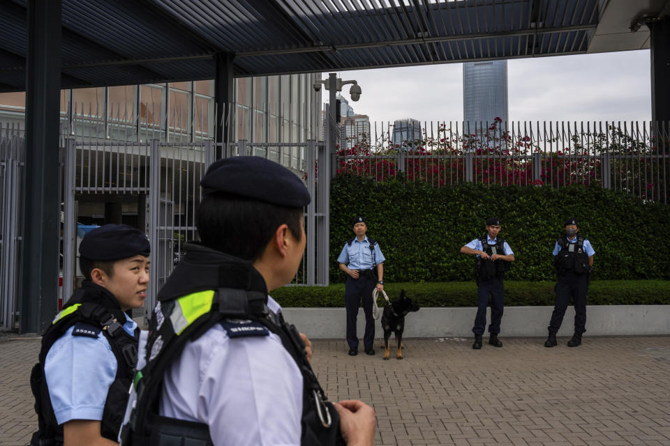 Police officers stand guard outside the Legislative Council in Hong Kong, Tuesday, March 19, 2024. Hong Kong's lawmakers met in a special session to resume debate on a proposed national security law Tuesday, paving the way to grant the government more power to quash dissent in the southern Chinese city. (AP Photo/Louise Delmotte)