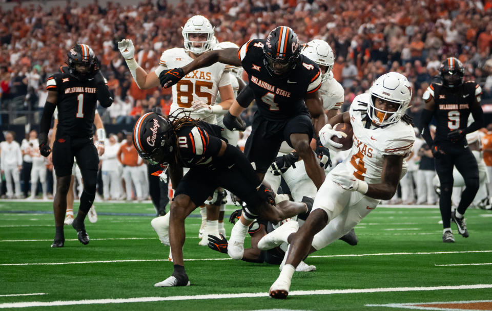 Dec 2, 2023; Arlington, Texas, USA; Texas Longhorns running back CJ Baxter (4) scores a touchdown against the Oklahoma State Cowboys in the second quarter of the Big 12 Conference Championship game at AT&T Stadium. Mandatory Credit: Sara Diggins/American-Statesman via USA TODAY NETWORK