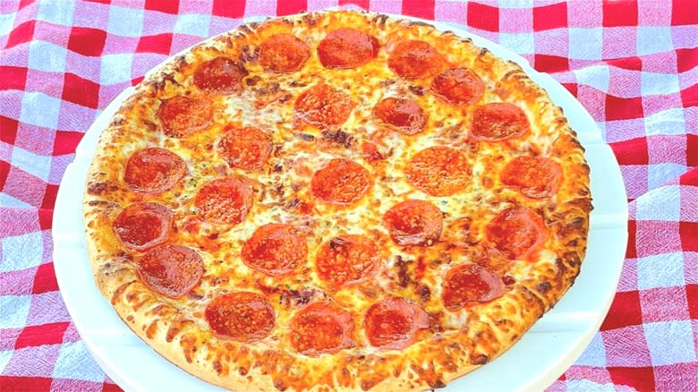 Pepperoni pizza on checkerboard background