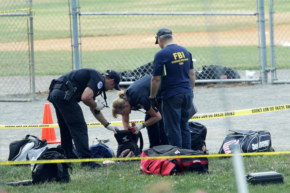 <p>Investigators search the bags that have been left behind at the Eugene Simpson Stadium Park where a shooting had happened June 14, 2017 in Alexandria, Va. (Photo: Alex Wong/Getty Images) </p>