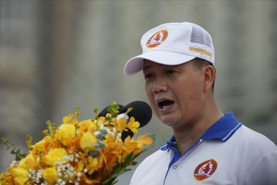 Hun Manet, front right, a son of Cambodia Prime Minister Hun Sen, delivers a speech before leading a procession to mark the end of an election campaign of Cambodian People's Party, in Phnom Penh, Cambodia, Friday, July 21, 2023. Hun Sen says he is ready to hand the premiership to his oldest son, Hun Manet, who heads the country’s army. (AP Photo/Heng Sinith)