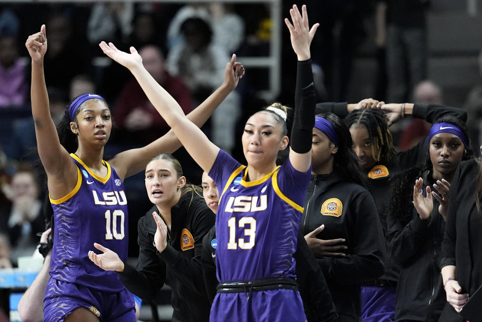 LSU guard Last-Tear Poa (13) and forward Angel Reese (10) react with teammates during the third quarter of a Sweet Sixteen round college basketball game against UCLA during the NCAA Tournament, Saturday, March 30, 2024, in Albany, N.Y. (AP Photo/Mary Altaffer)