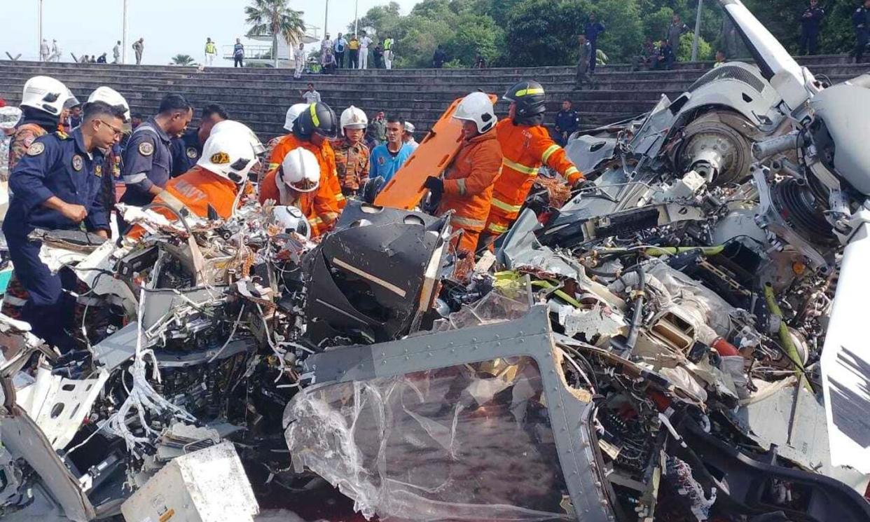 <span>All 10 people onboard two Malaysian navy helicopters were killed after they crashed in mid-air at the Lumut naval base in the western state of Perak.</span><span>Photograph: Terence Tan/AP</span>