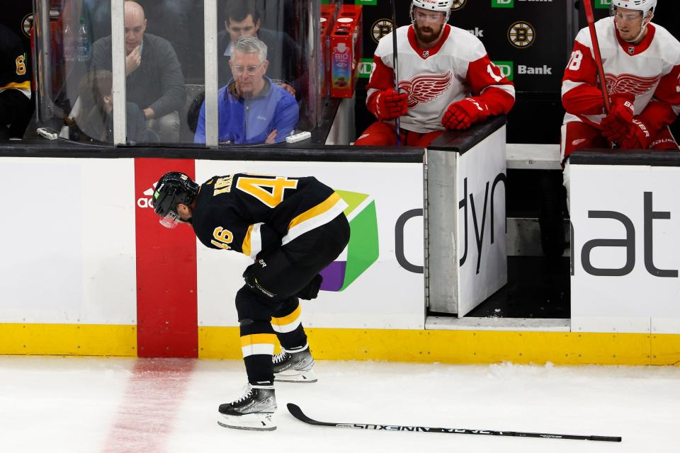 Boston Bruins center David Krejci (46) hunches over and leaves the ice after being injured against the Detroit Red Wings during the second period at TD Garden in Boston on Thursday, Oct. 27, 2022.