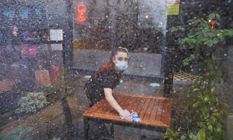 Staff put out tables at Crust pizza restaurant on Bold Street in Liverpool.