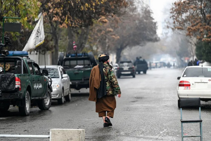 A member of the Taliban security forces walks near a site of an attack at Shahr-e-naw which is city's one of main commercial areas in Kabul on December 12, 2022. / Credit: WAKIL KOHSAR/AFP/Getty