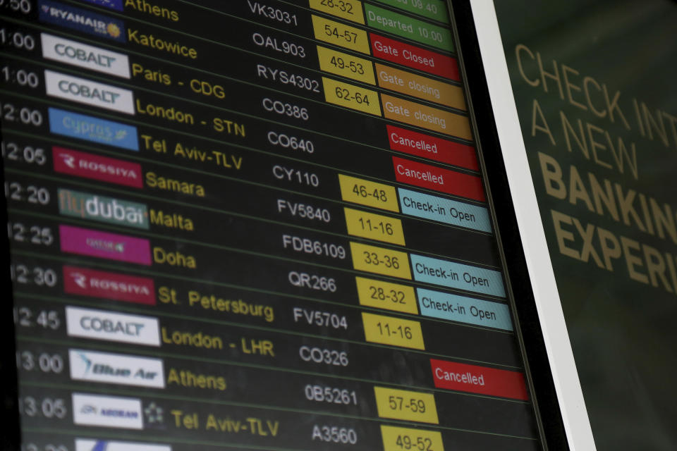 Airport departure board showing the Cobalt flights cancelled at Larnaca international airport, Cyprus, Thursday, Oct. 18, 2018. Cyprus-based airline Cobalt Air says it has indefinitely suspended all of its operations Thursday, amid a struggle to find investors. (AP Photo/Petros Karadjias)