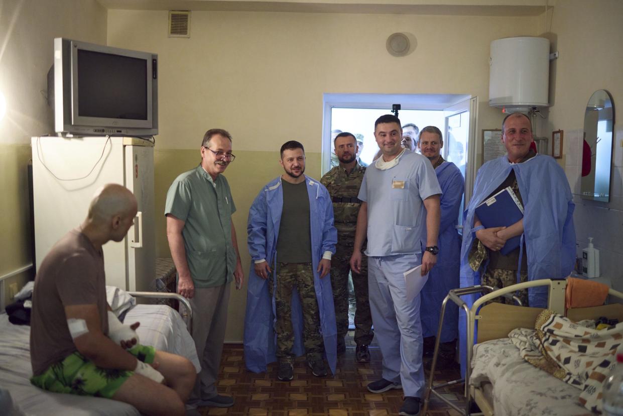 In this photo provided by the Ukrainian Presidential Press Office, Ukrainian President Volodymyr Zelenskyy, center, visits wounded soldiers in a city hospital in Odesa, Ukraine, on Friday.