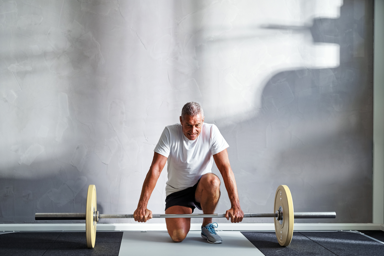 Senior man lifting a barbell