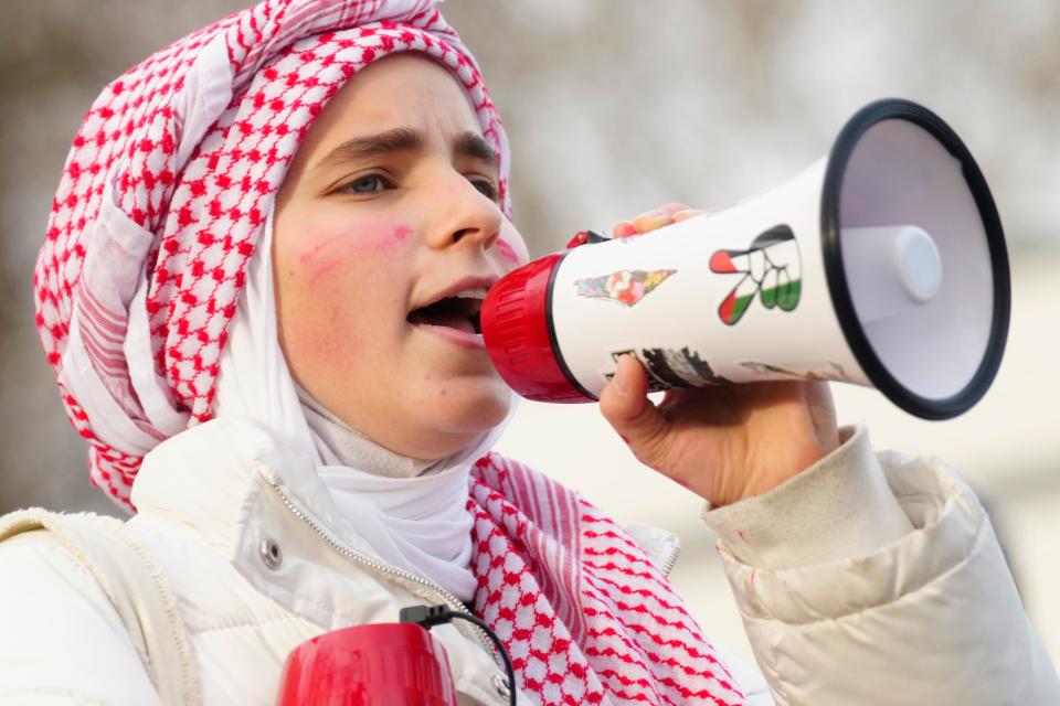Amar Halak, 17, a senior at Teaneck High School, holds a bullhorn during a rally to protest the war in the Middle East, Wednesday, November 29, 2023.