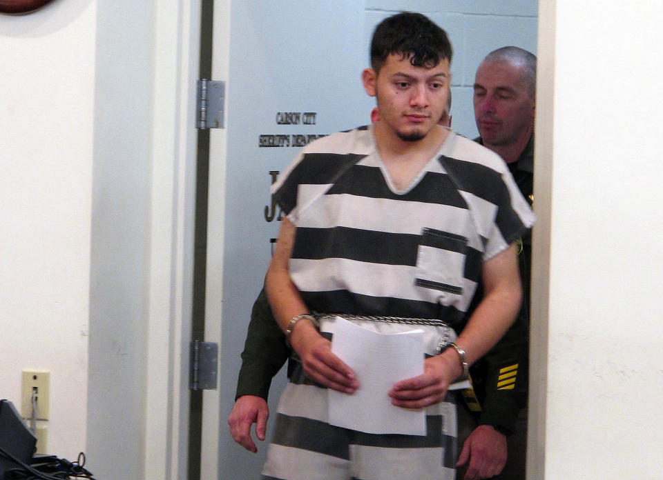 FILE - In this Jan. 24, 2019, file photo, Wilber Ernesto Martinez-Guzman, 19, of El Salvador, is escorted into the courtroom for his initial appearance in Carson City Justice Court in Carson City, Nev. The Nevada Supreme Court struck down a deadline Friday, April 9, 2021, that a district judge set later this month for the Salvadoran immigrant's lawyers to file a motion claiming he's intellectually disabled and therefore can't be executed if convicted of murdering a Reno couple and two other woman. (AP Photo/Scott Sonner, File)