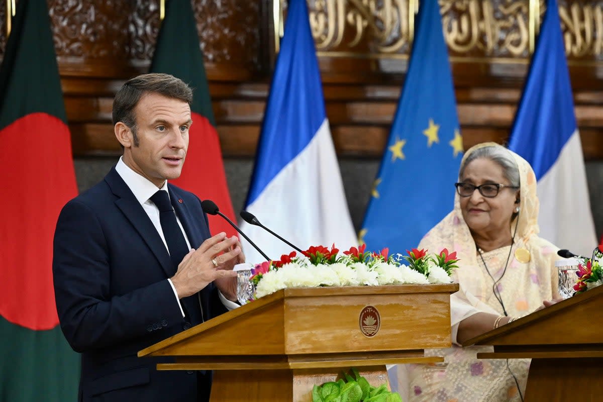 France’s president Emmanuel Macron (L) speaks as Bangladesh’s prime minister Sheikh Hasina looks on during the ceremony of signing bilateral agreements (AFP via Getty Images)