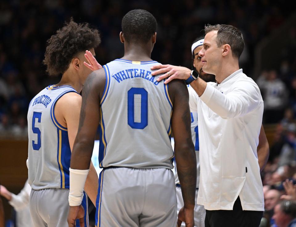 Jon Scheyer talks to his players during a game.